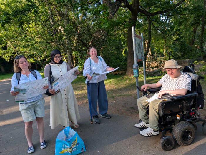 Three ladies with maps and a man in a wheelchair ready to play Beat the Street