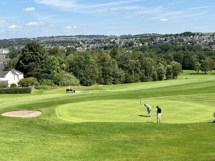 Golf course, with two men on a golfing green